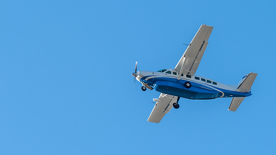 Cessna Grand Caravan 208B plane taking off from Miami International Airport.