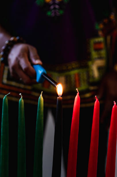 istock Kwanzaa celebration, close up lighting the kinara candle 1364314619