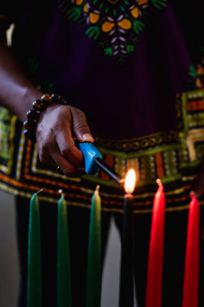 istock Kwanzaa celebration, close up lighting the kinara candle 1364314620