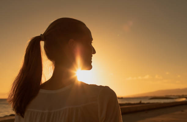 istock Woman enjoying beautiful sunset. 1364315526