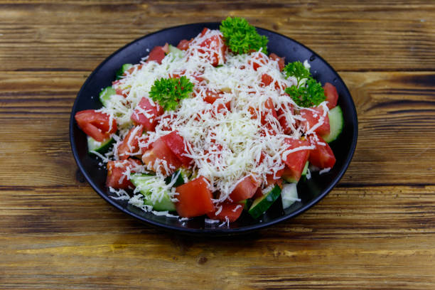 istock Traditional Bulgarian Shopska salad on wooden table 1364316925