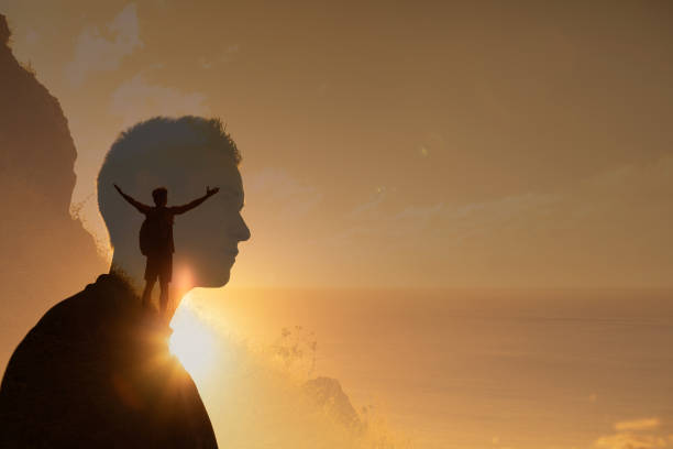 istock Man enjoying beautiful sunset from the mountain top. 1364318434