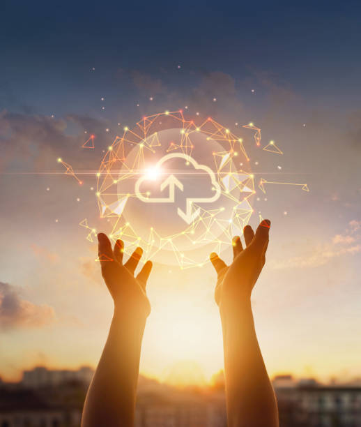 cloud computing and networking concept. hands touching global network and cloud icon on sunset background. - mobiles internet imagens e fotografias de stock