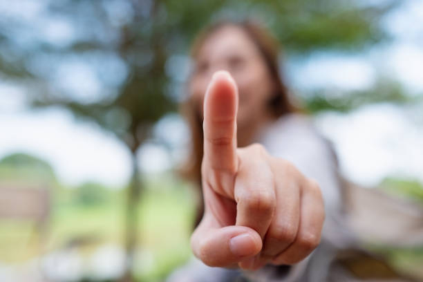 istock Blurred image of a woman touching or pointing finger at you 1364324799