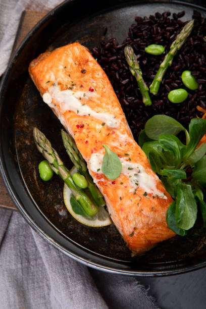 istock Baked salmon with asparagus and black rice. 1364328793
