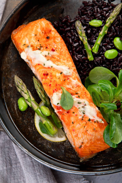 istock Baked salmon with asparagus and black rice. 1364328874