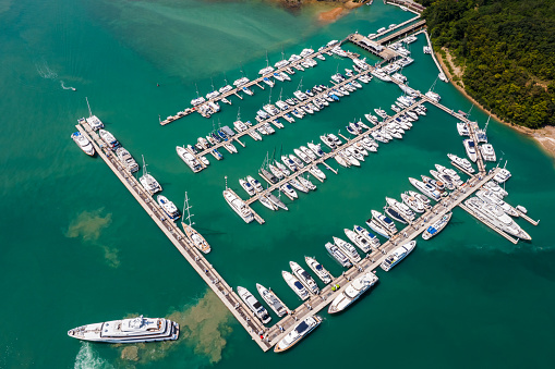 yachts and boats in marina bay at Phuket Thailand Aerial view