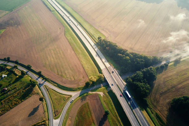 istock Car traffic on highway at summer day, aerial view 1364339889