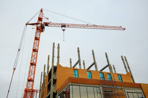 istock High rise construction crane on background of an unfinished multi storey and multi apartment residential building. 1364344868