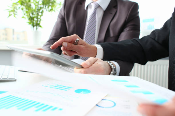 istock Two businessmen looking and studying analytics and business statistics 1364354629
