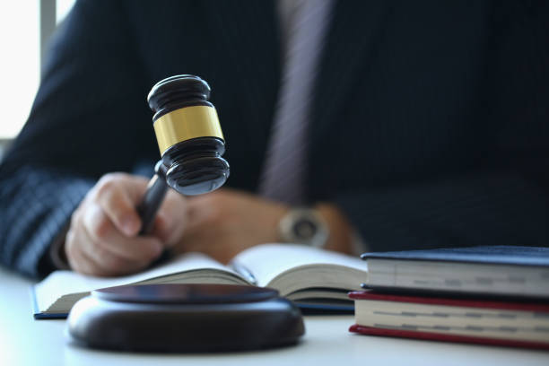 Male judge in courtroom hits with hammer Male judge in courtroom hits with hammer. Court session on consideration of criminal case in court concept arm hammer stock pictures, royalty-free photos & images