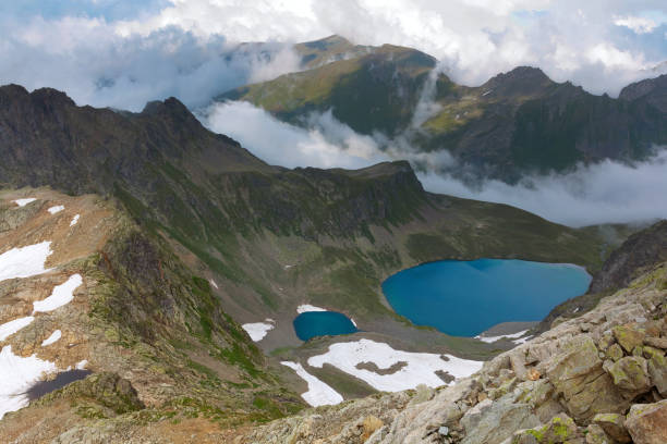 istock caucasian mountain valley in a clouds 1364358313