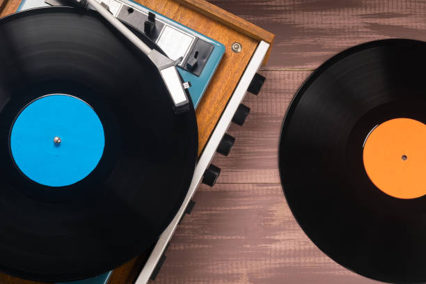 istock vinyl record in an old turntable, close-up top view 1364358687