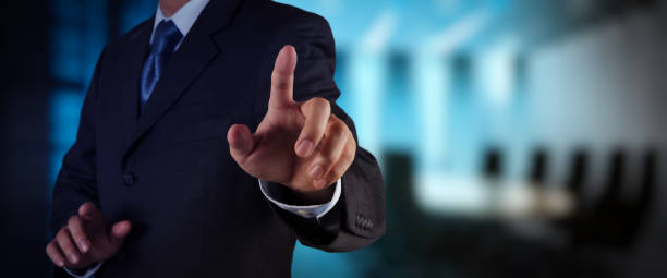 istock businessman working on VR blank wide touch screen computer on office blur background. 1364358745