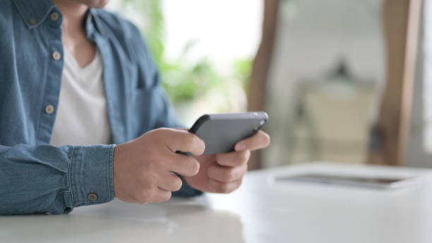istock Close Up of Hand using Smartphone, Mobile 1364360127