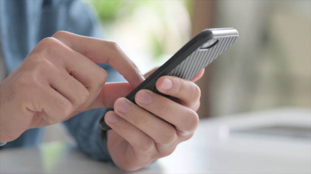 istock Close Up of Man Browsing Internet on Smartphone 1364360341