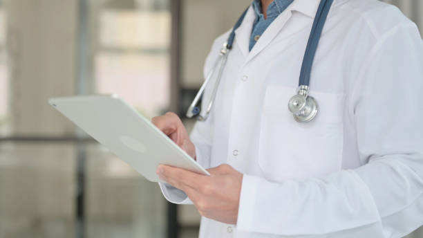 istock Close up of Doctor working on Tablet 1364362212