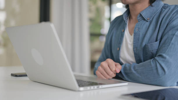istock Close Up of Man Counting Dollars while Working on Laptop 1364362575