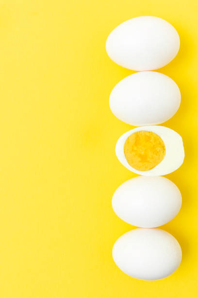 istock Creative photos of a boiled chicken egg on a yellow background 1364363578