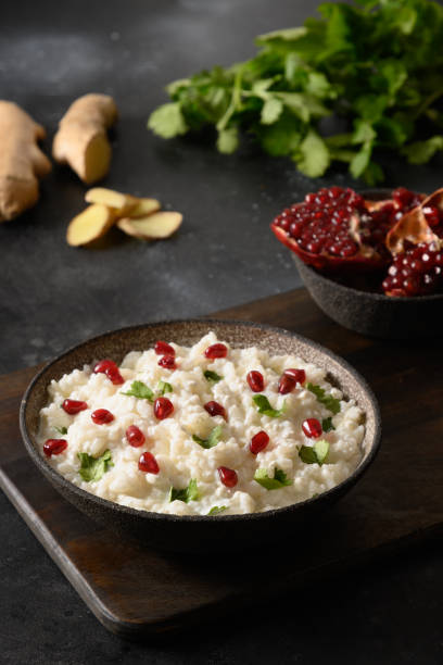 istock Curd Rice with pomegranate, cilantro, mustard seeds, ginger on a black background. Indian cuisine 1364364007