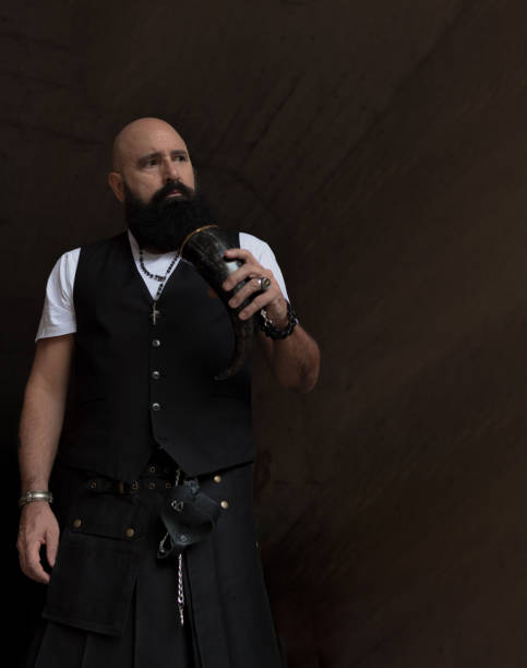 istock bald man with nice beard standing in a tunnel while holding a driking horn 1364364123