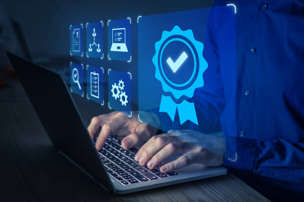 istock Certification and standardization process, quality assurance and conformity to international standards. Concept with icons for certificate, approval, compliance to requirements. Person using computer 1364365591