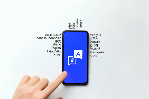 istock Translation concept. The hand clicks on a smartphone with an application. 1364367006