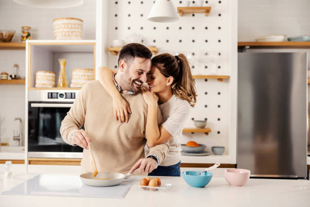 istock A happy couple making breakfast in the kitchen at their cozy home. 1364367041