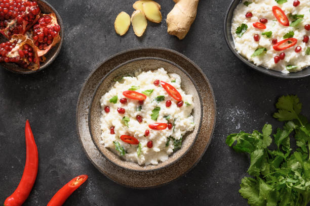 istock Curd Rice with pomegranate, cilantro, ginger on a black background. 1364367246
