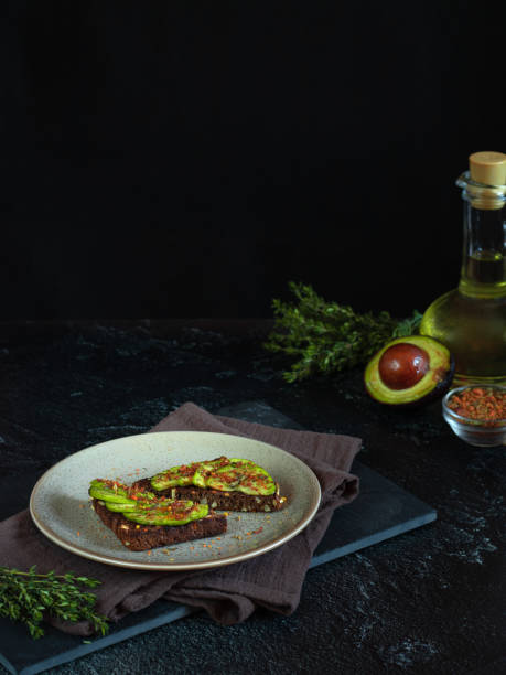 Healthy grain bread sandwich with avocado slices, Svan salt and spices.