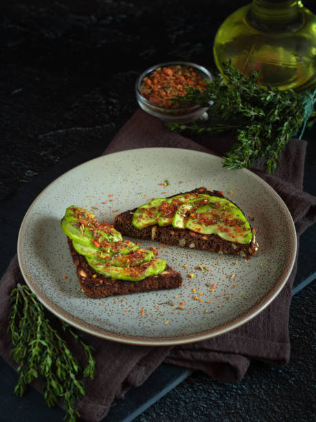 Healthy grain bread sandwich with avocado slices, Svan salt and spices.