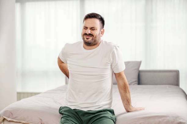 istock A morning man having back pain in the bedroom. 1364368570