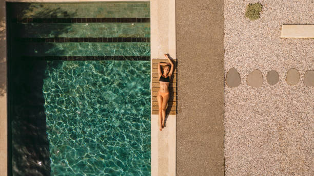 istock Enjoying the sunny day by the pool 1364369742