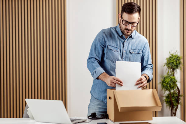 istock An organized entrepreneur arranges paperwork at his home office. 1364370127