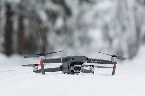 Vyborg, Russia - January 12, 2022: The photo of Dji Mavic 2 pro quadcopter was taken on January 12, 2022. The photo shows the Dji Mavic 2 pro quadcopter on a snowy road in a winter forest.