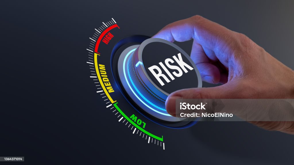 Risk management and mitigation to reduce exposure for financial investment, projects, engineering, businesses. Concept with manager's hand turning knob to low level. Reduction strategy. Risk Stock Photo