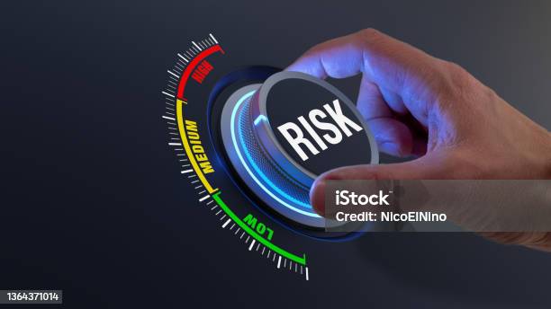 Risk Management And Mitigation To Reduce Exposure For Financial Investment Projects Engineering Businesses Concept With Managers Hand Turning Knob To Low Level Reduction Strategy Stock Photo - Download Image Now