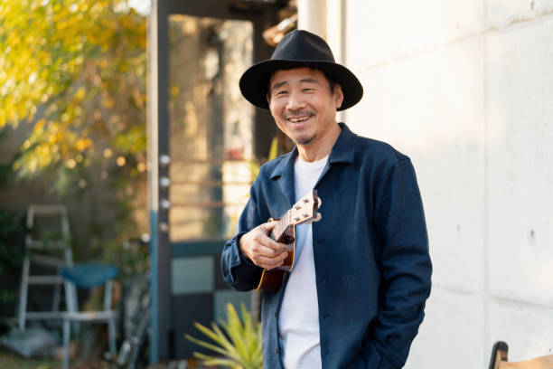 istock Portrait of a mature man outdoors with an ukulele 1364372331