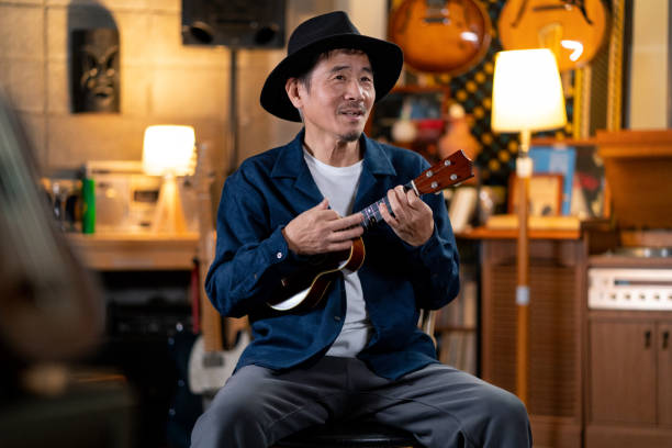istock Mature Japanese male playing the ukulele 1364372852