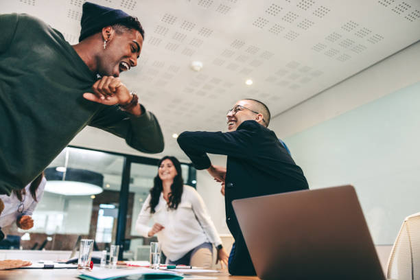 istock Bubbly businesspeople elbow bumping each other before a meeting 1364372934