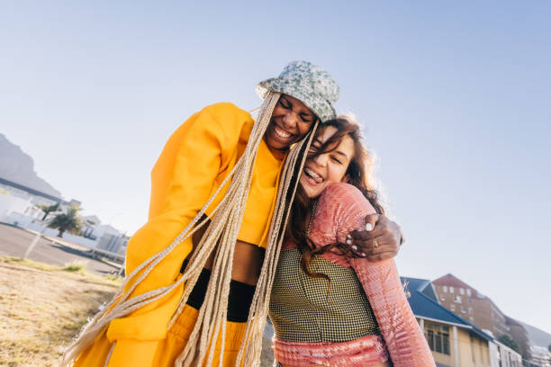 istock Best friends laughing and embracing each other 1364374626