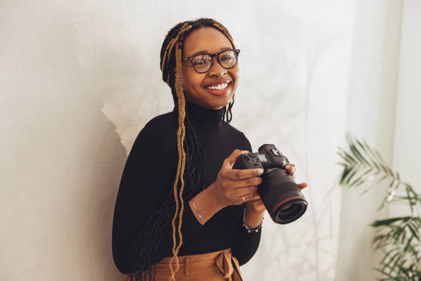 istock Happy young photographer smiling at the camera 1364374975