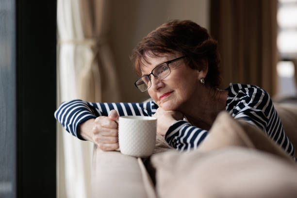 istock Happy senior woman with coffee 1364375111