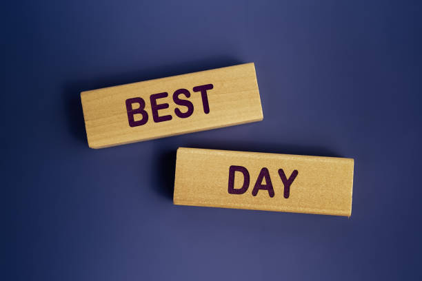 istock Wooden blocks form the words 'BEST DAY' on a dark blue background. Concept text 1364375671