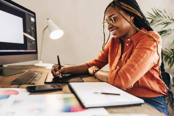istock Happy young designer drawing on a graphics tablet 1364376226