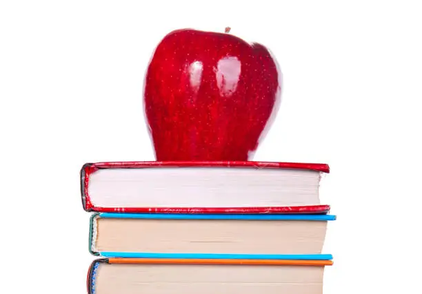 Red Apple on the Books Isolated on the White Background