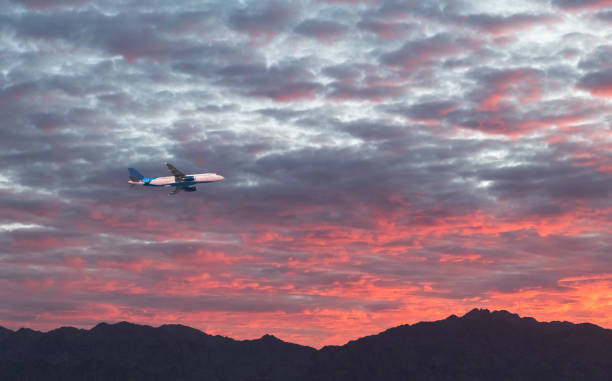 istock International flight above beautiful mountains at dawn 1364379012