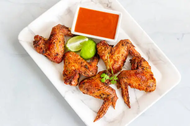 Oven Baked Crispy Chicken Wings on a Platter Top Down Chicken Appetizer Photo