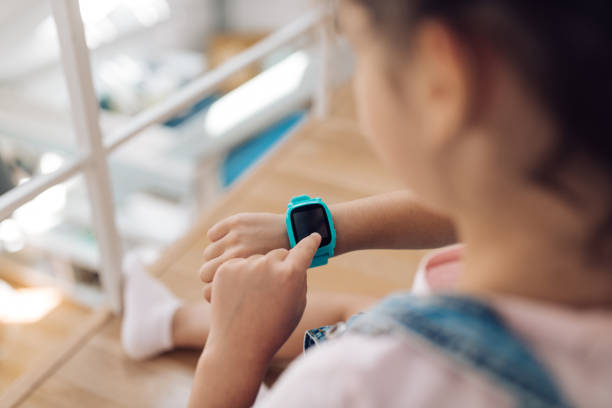 istock Little girl adjusting her  smartwatch 1364381354