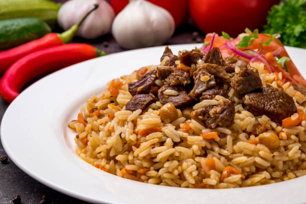 istock pilaf with beef and vegettables salad on white plate on dark table macro close up 1364382889